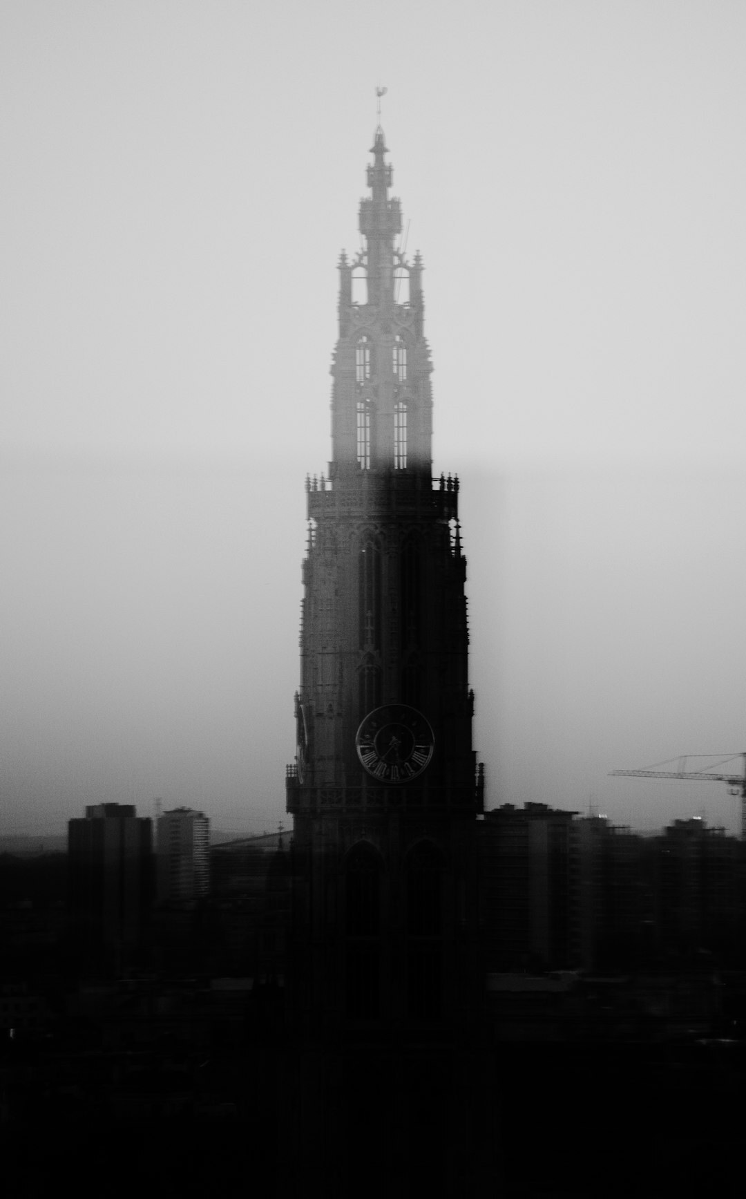Silhouette of Antwerp cathedral against a dramatic evening sky
