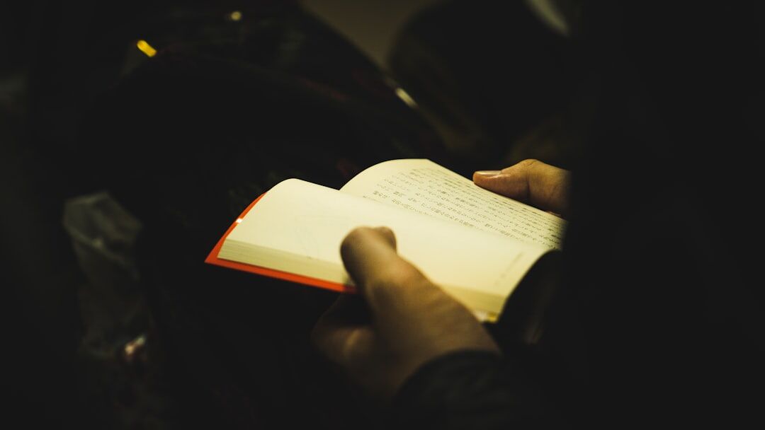 person reading mystery book at night